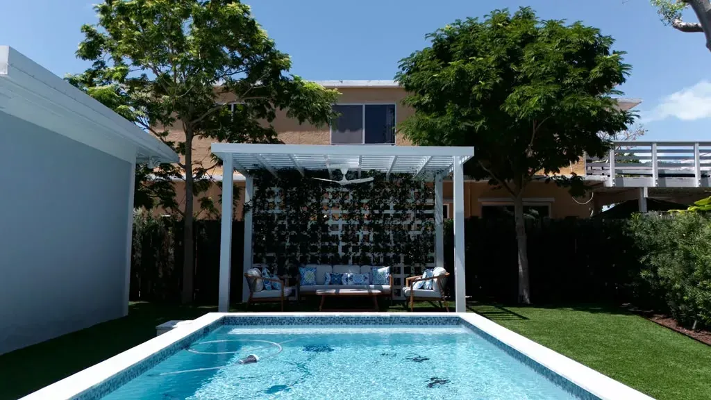 Palms framing a pool and pergola at a Florida Keys home